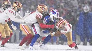 Image of men playing football in the snow