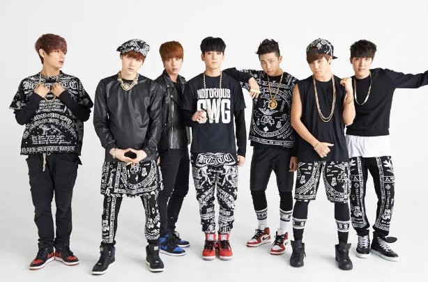 photo of a boy band dressed in white and black