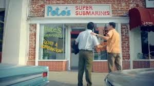 Subway beginning as Pete's Sub shop. two men standing on front of a building