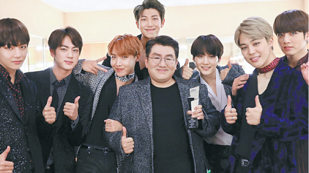 Photo of BTS boy band with their producer