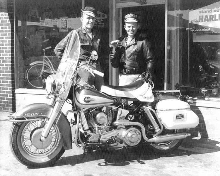 black and white photo of men in front of a building 