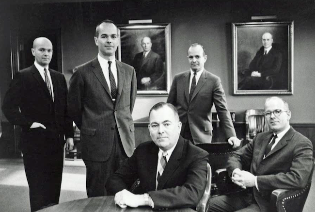 piture of men sitting in chairs