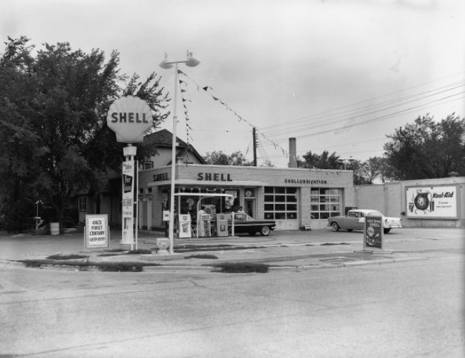 black and white image of old shell gas station