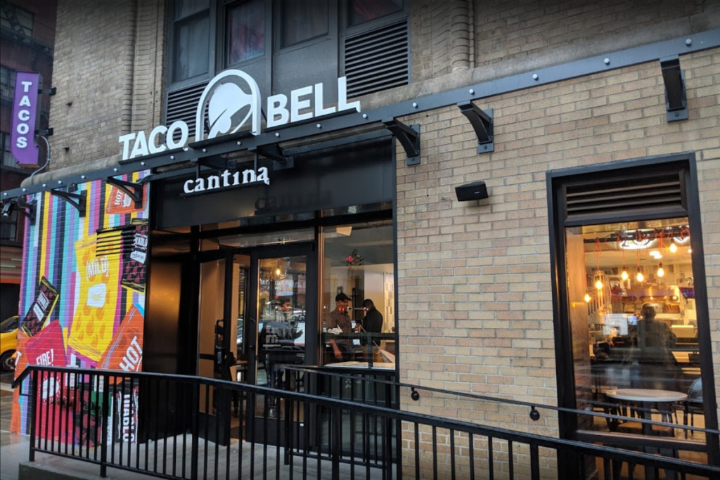 taco bell logo on side of building in a city