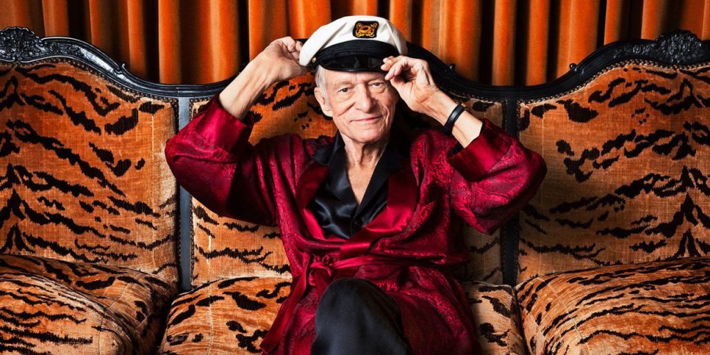 High Hefner: photo of old man wearing a hat sitting on a couch